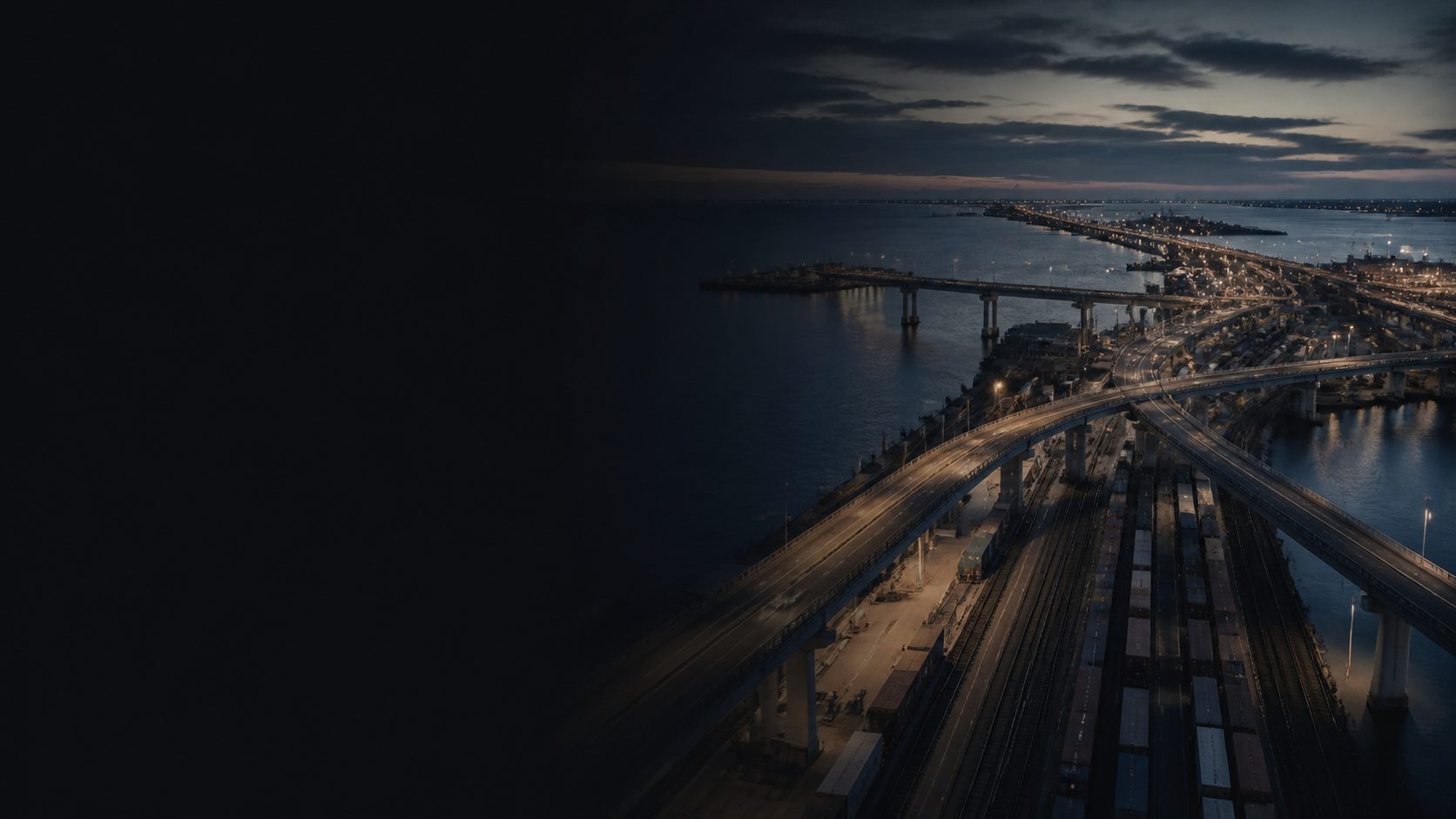 Intermodal road and rail routes converging at a port at blue hour